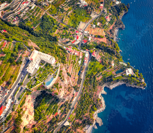 Obraz na płótnie Stright down view from flying drone of Santa Maria di Grado palace, located on the huge cliff on Mediterranean coast of Italy. Nice summer scene of italian countryside. Traveling concept background. w salonie