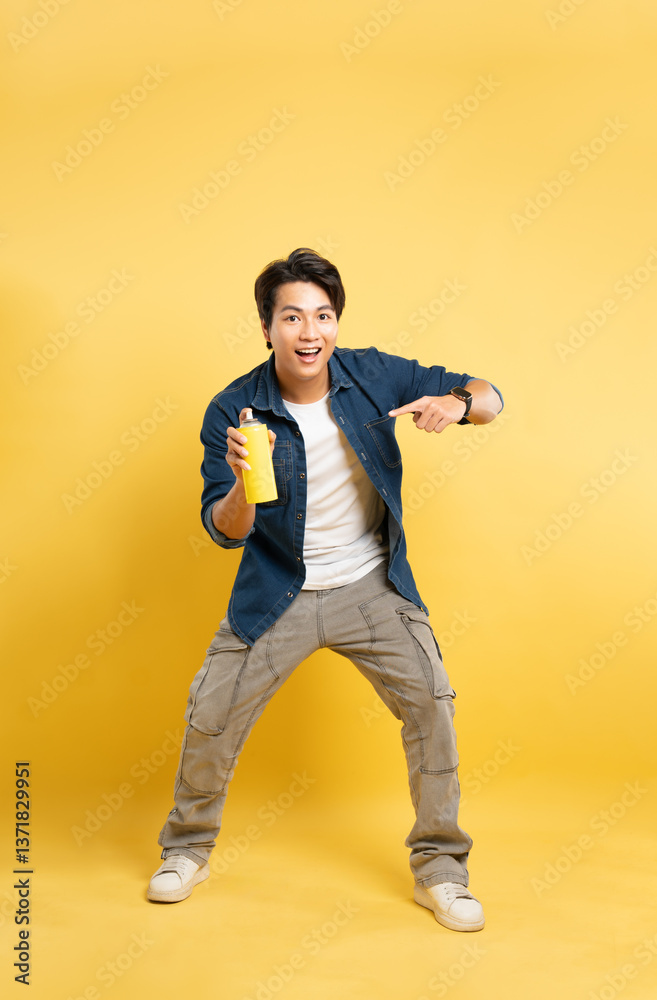 portrait of a man holding a paint vase posing on a yellow background, portrait of a man holding a paint vase posing on a yellow background,