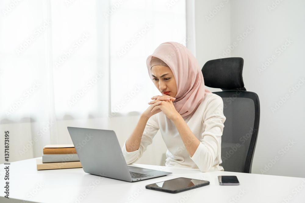 Stressed asian muslim business woman working in the office hands on head feeling headache. Tired islamic muslim woman looking at laptop working hard sitting in the room office. Overtime concept Stressed asian muslim business woman working in the office hands on head feeling headache. Tired islamic muslim woman looking at laptop working hard sitting in the room office. Overtime concept