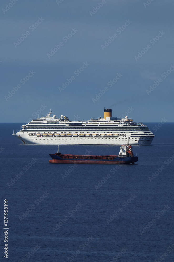 Mega family cruiseship cruise ship liners Favolosa and Fortuna anchored offshore of Civitavecchia Rome, Italy before reactived after Covid pandemic with other vessels in port and coastline