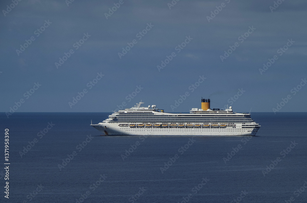 Mega family cruiseship cruise ship liners Favolosa and Fortuna anchored offshore of Civitavecchia Rome, Italy before reactived after Covid pandemic with other vessels in port and coastline
