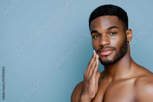 man with smooth skin gently touching his face, showcasing self care routine against blue background