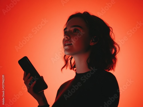 Woman using phone with red background