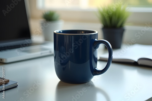 A mockup of a navy blue ceramic mug on a modern office desk, complemented by a laptop, notebooks, and a stylish plant, creates a professional workspace.