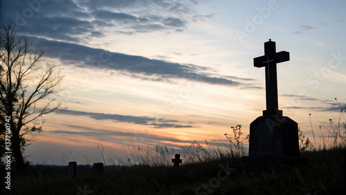 silhouette of cross stands prominently in cemetery against vibrant sunset sky for websites or blogs relating to faith, remembrance,spirituality,or even travel destinations featuring historical cemeter