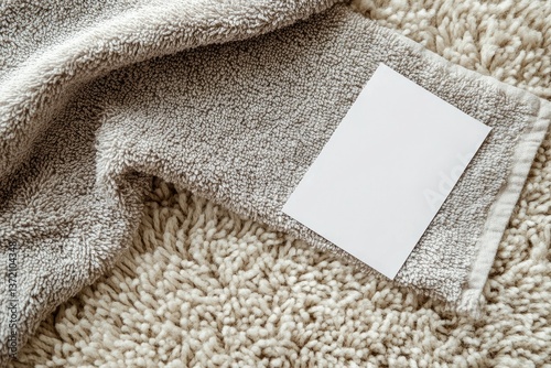 Clear Pixel Visual of Grey Terry Towel with White Empty Label on Beige Pile Carpet