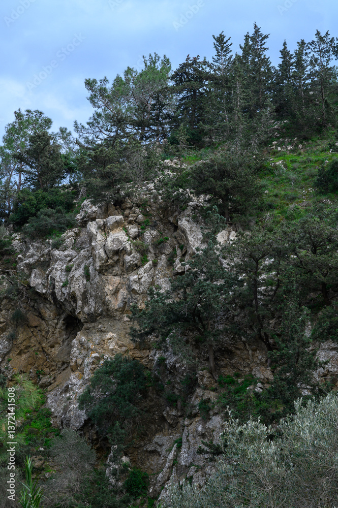 Adventurous hikers exploring rugged terrain under a cloudy sky in a serene mountainous region during the early morning hours Adventurous hikers exploring rugged terrain under a cloudy sky in a serene mountainous region during the early morning hours