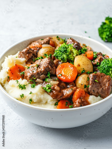 Hearty beef stew with vegetables over egg noodles garnished with fresh parsley