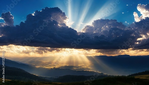 A dramatic cloudscape at dusk with rays of light breaking through, casting a beautiful glow over the landscape below