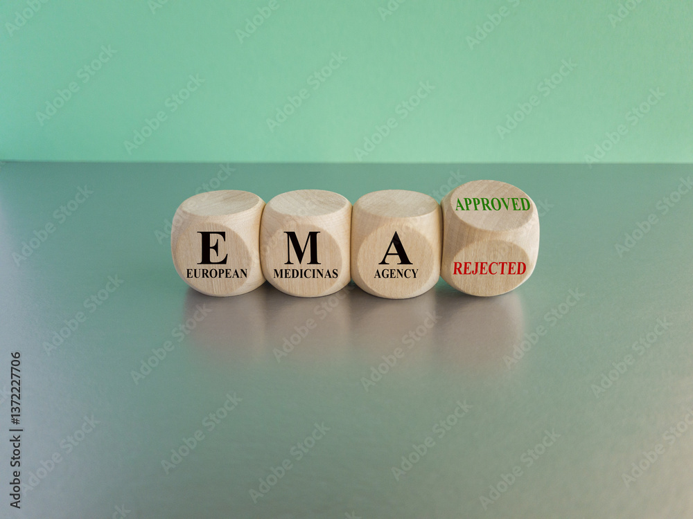Dices form the expression EMA (European Medicines Agency) approved or rejected. Beautiful blue background, gray table. Medical concept.