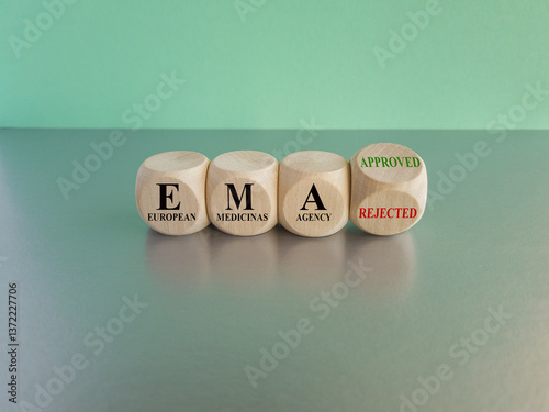 Obraz na płótnie Dices form the expression EMA (European Medicines Agency) approved or rejected. Beautiful blue background, gray table. Medical concept. w salonie