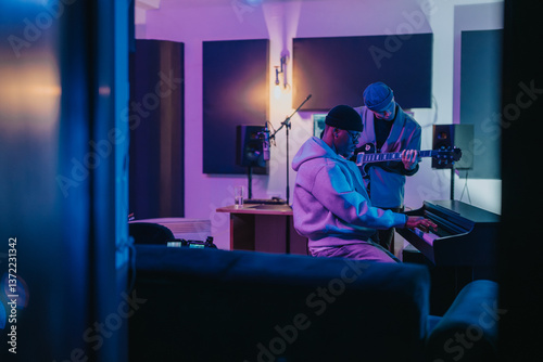 Quadro su tela Diverse group of musicians working together on music production inside a professional studio