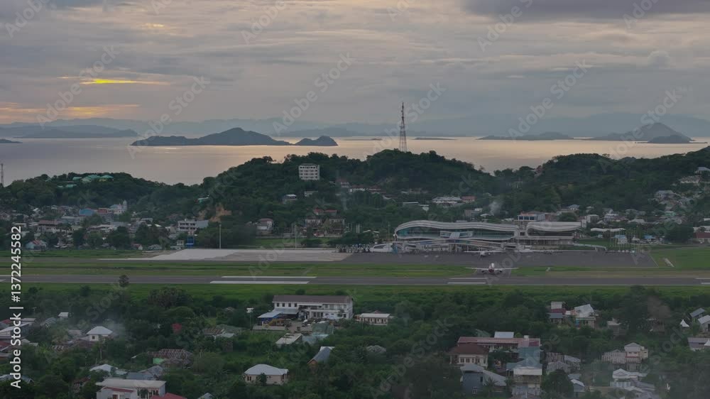 LABUAN BAJO, INDONESIA - JANUARY 4, 2025 : A AirAsia Leaving from Komodo Airport Labuan Bajo during Sunset 