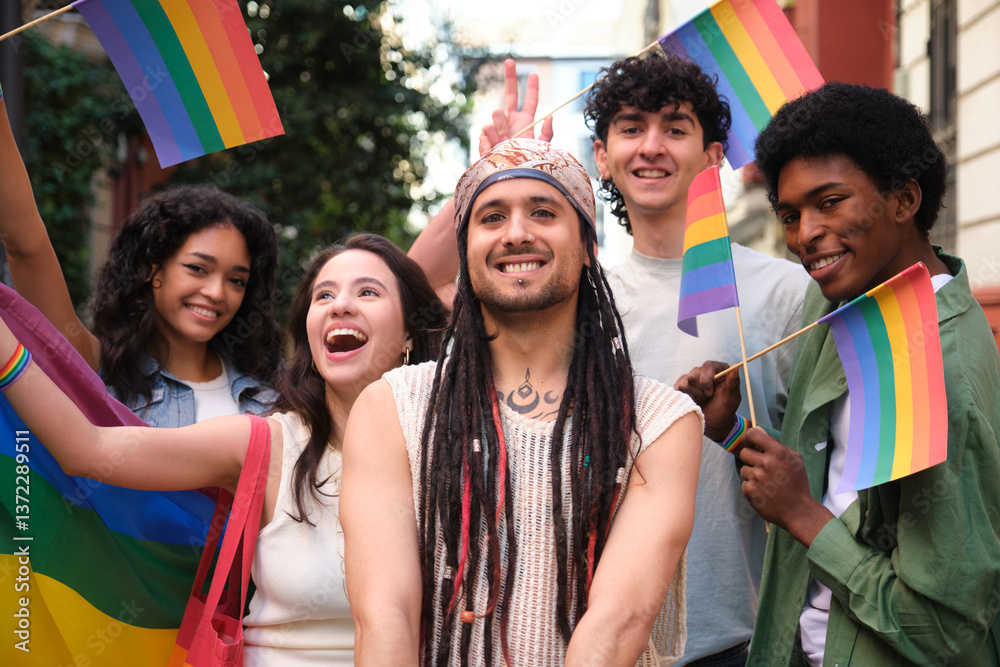 Group of cheerful multi ethnic friends celebrating LGBT pride holding rainbow flags
