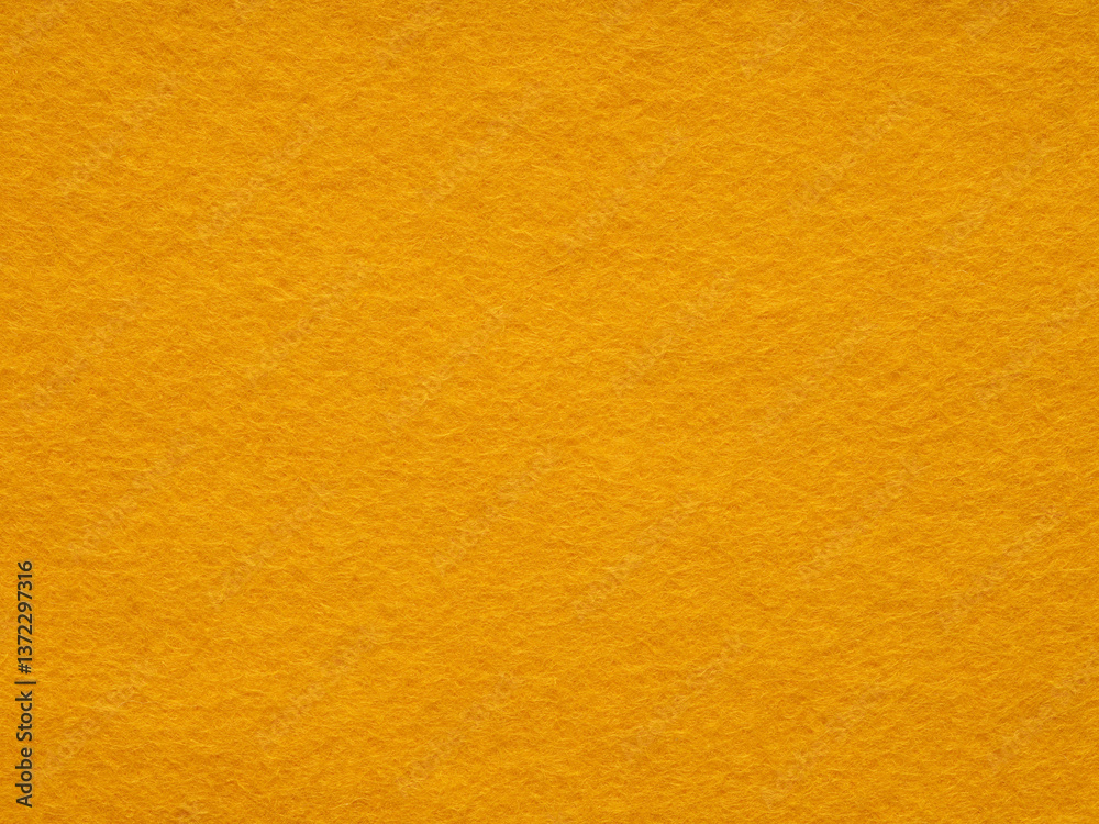A warm embrace of golden hues, the felt surface radiates a cozy, soft texture and a simplistic, minimalist style
