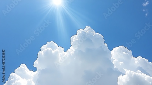 Brilliant sun shining above fluffy white clouds in a blue sky