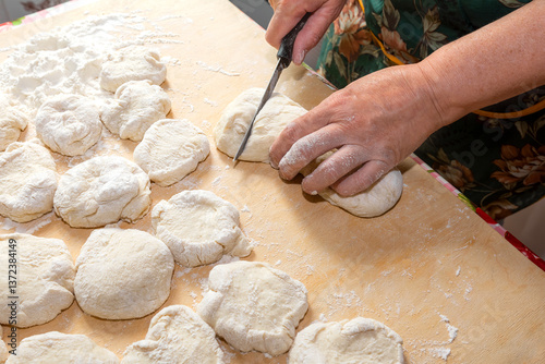 A housewife is preparing the dough for baking Easter cakes and pies.