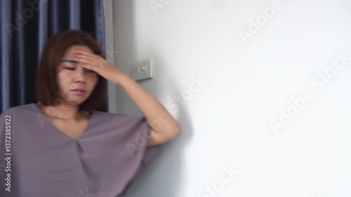 asian woman feeling tired and dizzy from anemia, suddenly experiencing vertigo, headache, and trouble balancing, possibly due to low iron, heat stroke, or blood circulation problems