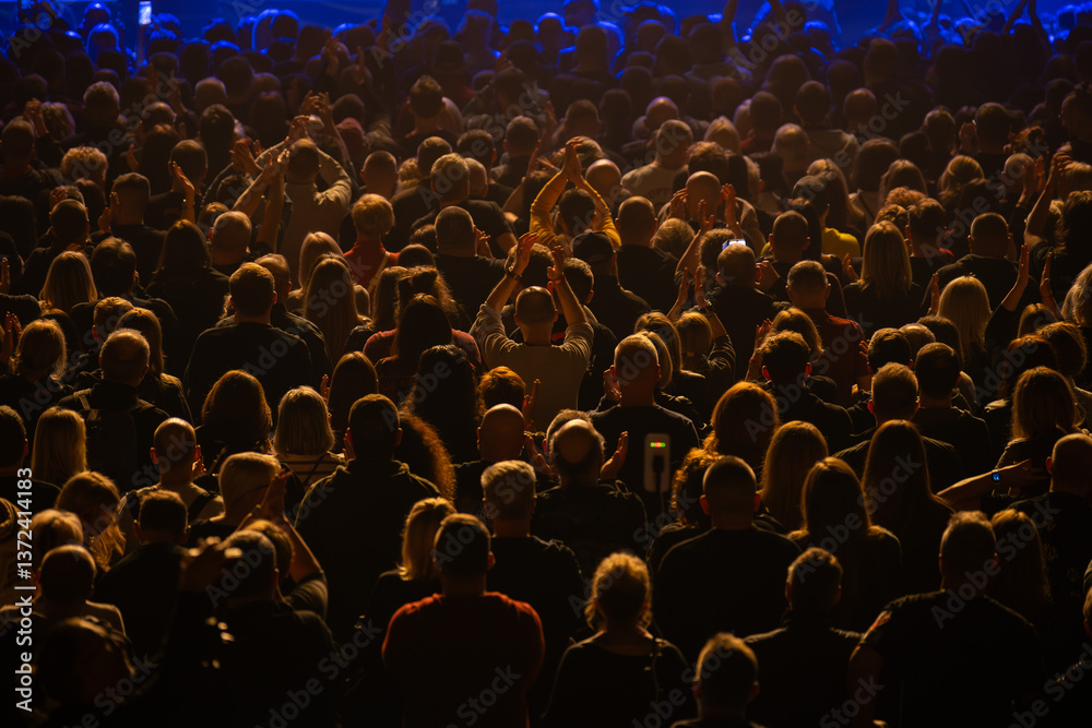Obraz premium Crowd of people in front of the stage during the concert.