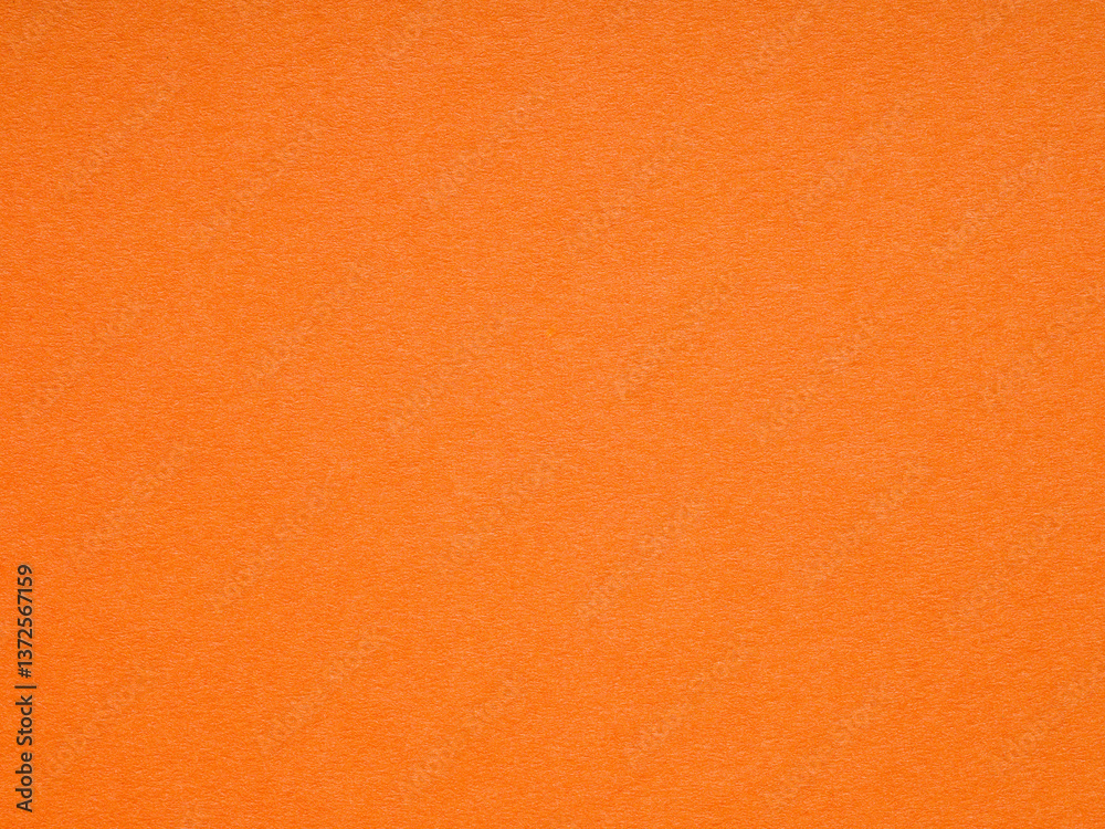 Vivid orange paper texture sparking imagination with a burst of lively color
