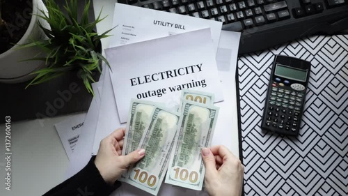Hands counting cash with utility bills, money counting and household budgeting, power and heat payment document