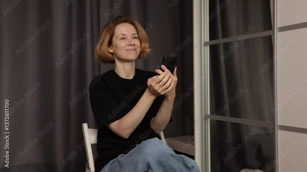 Excited Woman Reacting to Phone Screen, showing enthusiasm and triumph, holding phone while reading an emotional message. Excited Woman Reacting to Phone Screen, showing enthusiasm and triumph, holding phone while reading an emotional message.