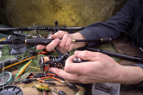 Foto Fishing tackle on a table in a composition with fishing accessories