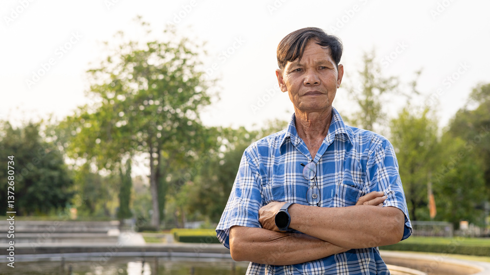 Man Posing With Arms Crossed in a Tranquil Park During Late Afternoon Man Posing With Arms Crossed in a Tranquil Park During Late Afternoon