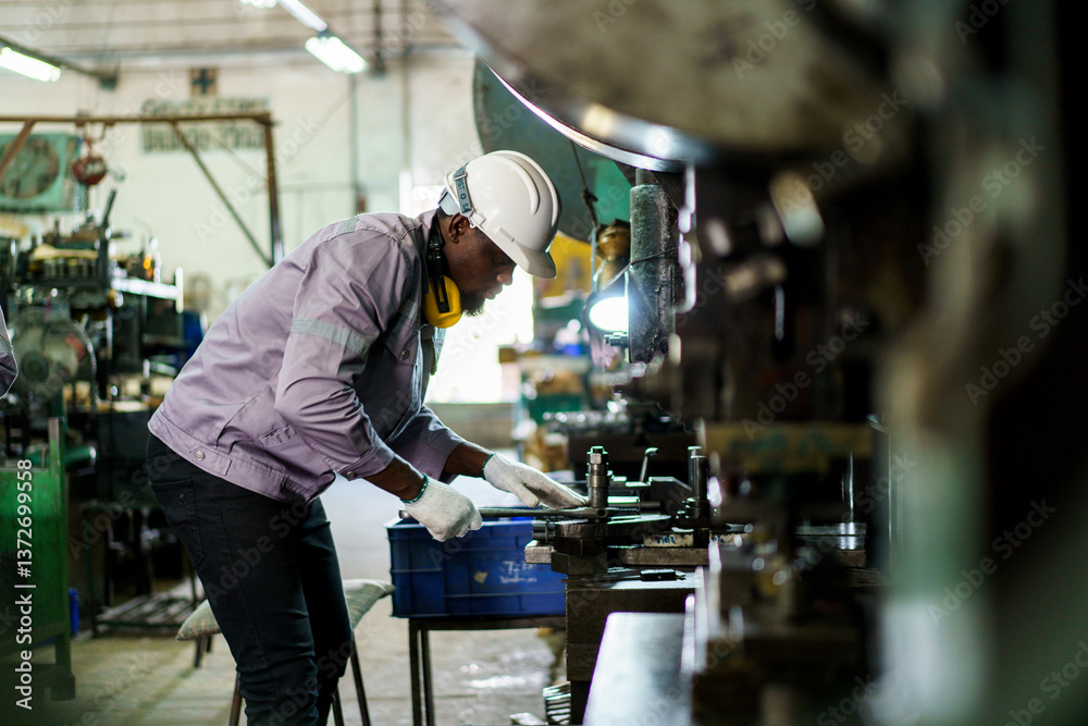 African black male engineer portrait in factory.