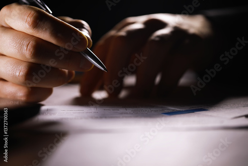 Obraz na płótnie Close-Up of Hand Writing on Document with Pen Under Dim Light w salonie