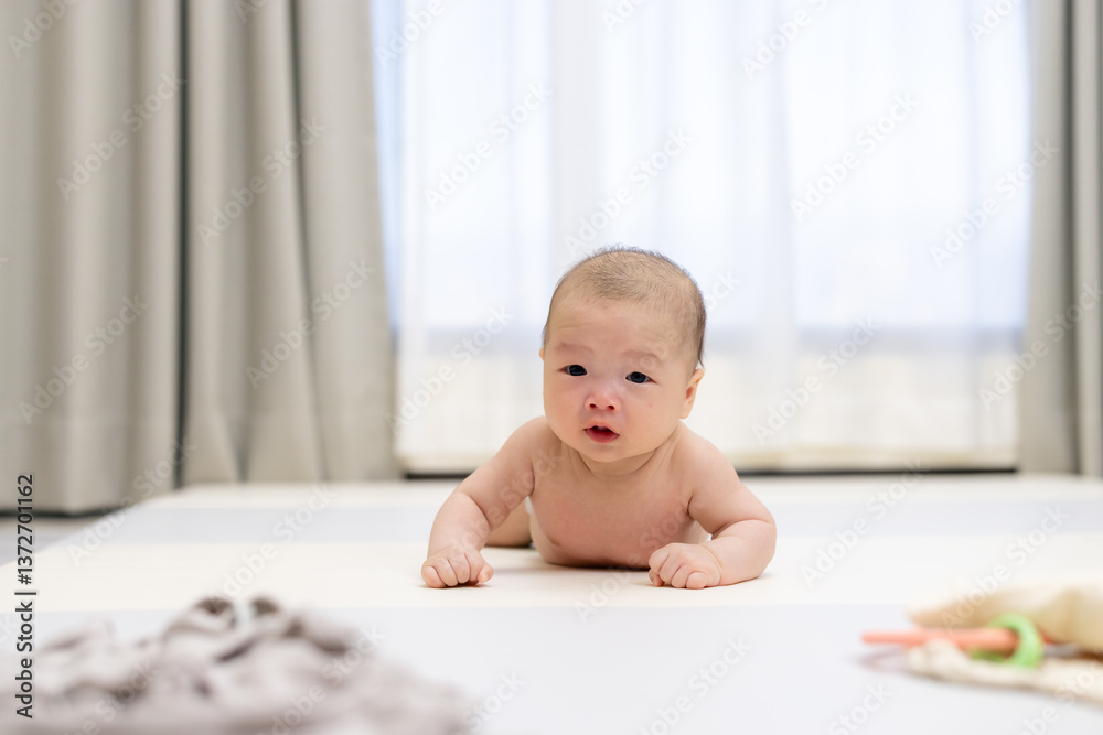 Cute baby lying on tummy looking forward