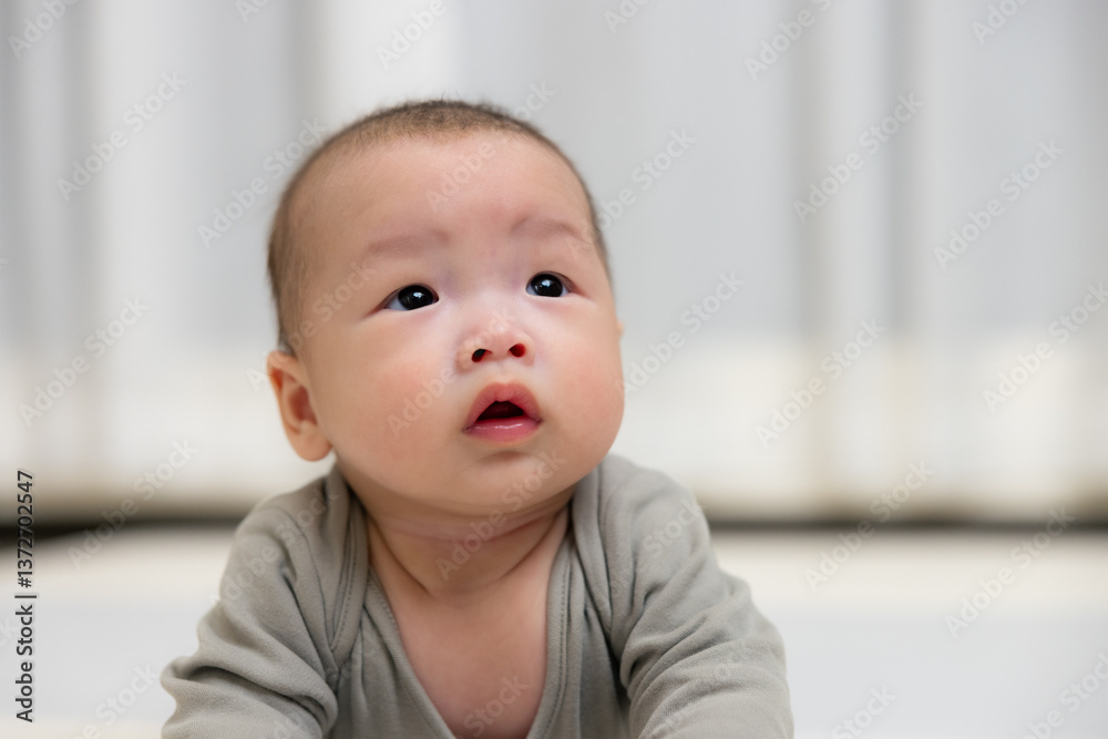 Cute baby looking up with curious expression