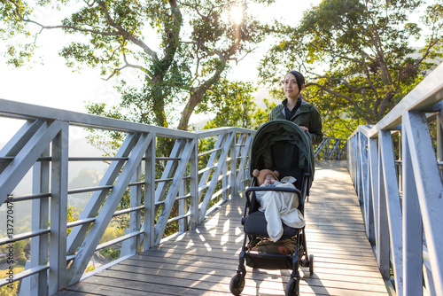 Obraz na płótnie Hiking woman walk with baby stroller along trail w salonie