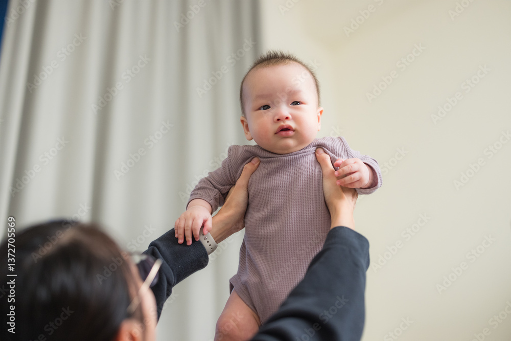 Mum holding baby up with both hands