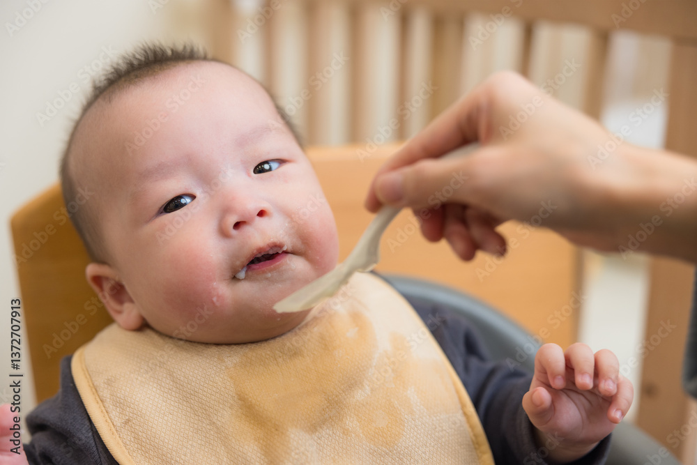 Parent feeding baby healthy soft meal
