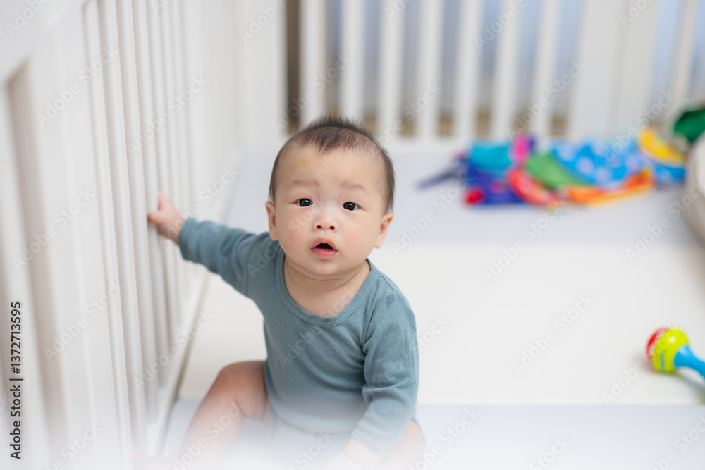 Little baby looking curious in crib