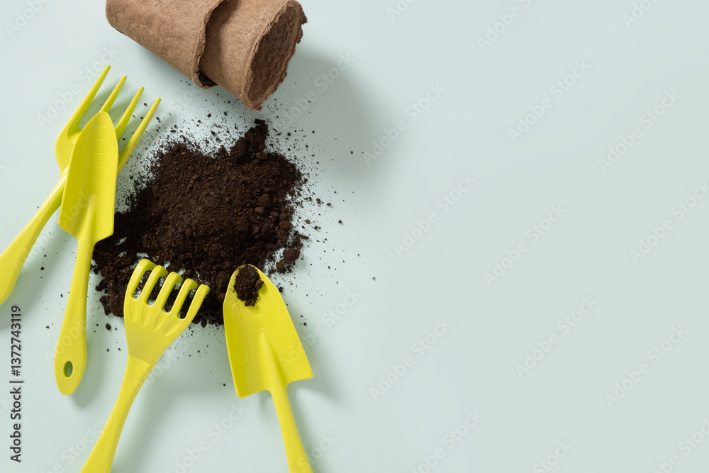 Various gardening hand green tools and soil on blue background. Spring gardening. Concept season work and hobby. Copy space. Top view.