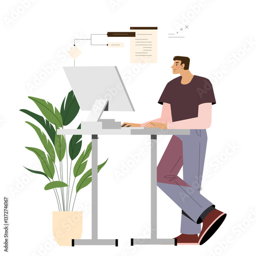 A man works at a computer while standing at a table.