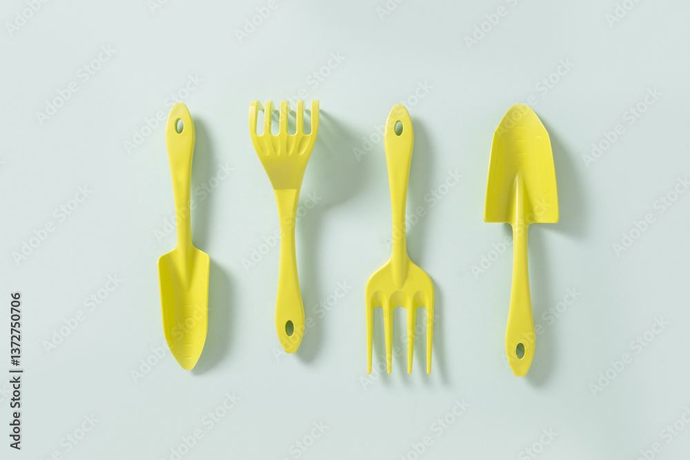 Various gardening hand green tools plastic isolated on blue background. Spring gardening. Concept season work. Top view.