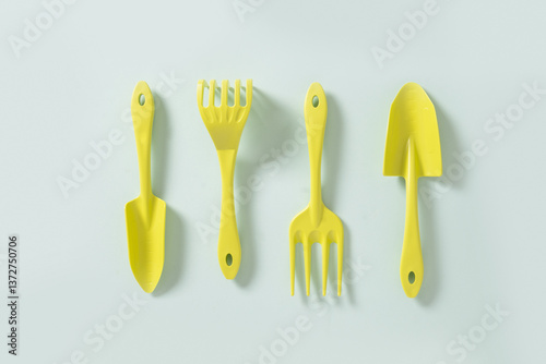 Obraz na płótnie Various gardening hand green tools plastic isolated on blue background. Spring gardening. Concept season work. Top view. w salonie