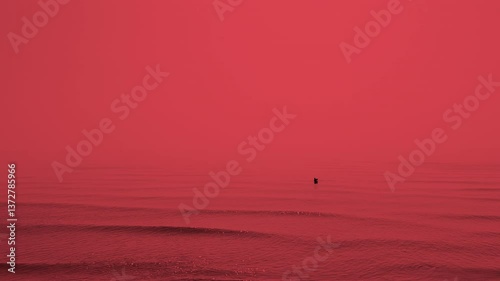 A simple seascape with striking dark red tones, calm waves and a fisherman holding a fishing net in the distance. The abstract composition creates a sense of calm and mystery.