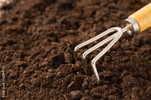 Obraz na płótnie Garden hand cultivator on soil. Hand rakes. Hobby. Close up. w salonie