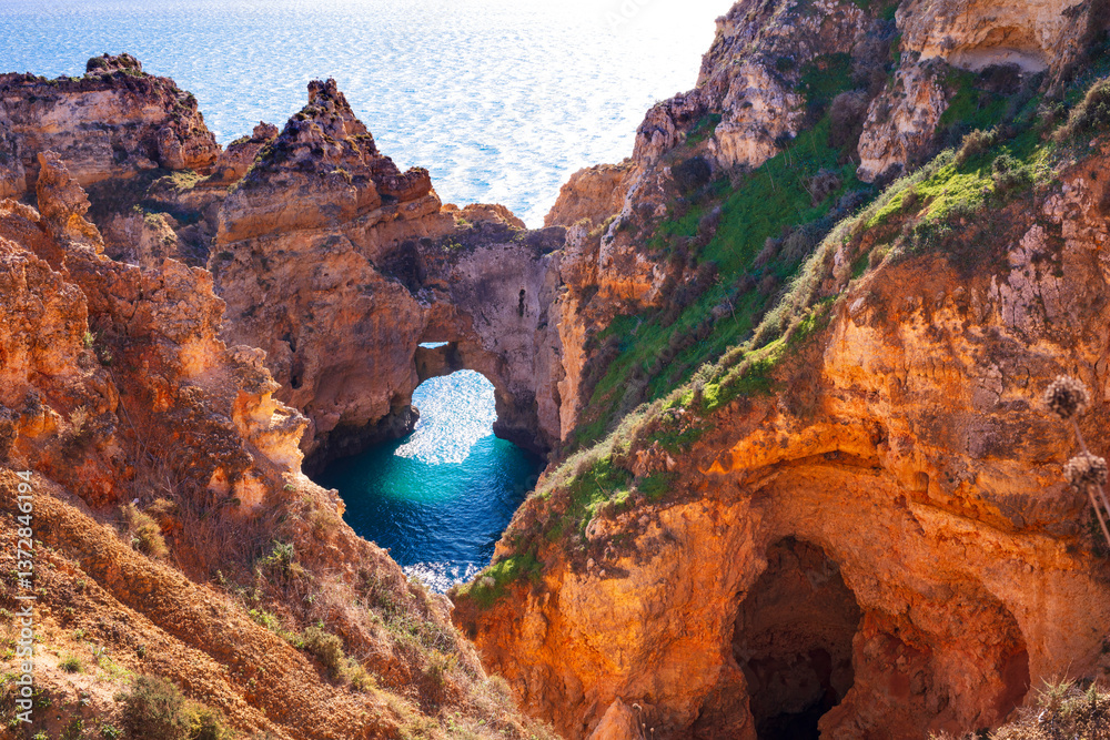 Amazing rocky scenic becahes of Algarve coast, Portugal. Breathtaking famous beach Praia da Marinha with yellow rocks with arc .