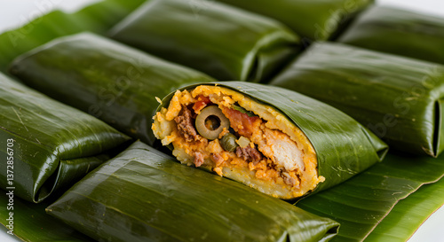 Authentic Venezuelan hallacas wrapped in vibrant green banana leaves arrangement