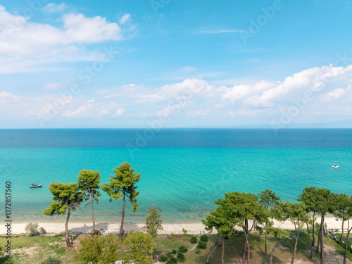 Aerial travel shot Kassandra Greece, coastal Mediterranean village, blue sea,  pine forest, summer resort atmosphere, perfect beach destination, tranquil nature scene, tourism concept. Travel