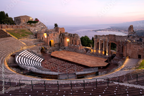 Teatro Antico di Taormina with view over the bay and Mount Etna in the background.  Remains of the Greco-Roman theatre