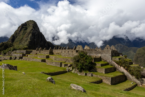 View over terracing fields in Machu Picchu with Huayna Picchu Mountain in the background