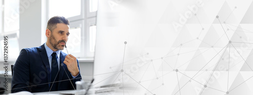 Thoughtful middle aged businessman working on computer sitting in office, man entrepreneur thinking about new business project or startup at workplace. Business career concept, copy space