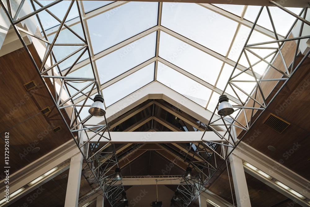 As I gaze up, I cant help but admire the intricate and beautiful design of the ceiling along with the stunning glass roof that allows natural light to flood into the entire building As I gaze up, I cant help but admire the intricate and beautiful design of the ceiling along with the stunning glass roof that allows natural light to flood into the entire building