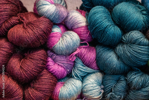 Colorful hand-dyed skeins of wool yarn in jewel tones